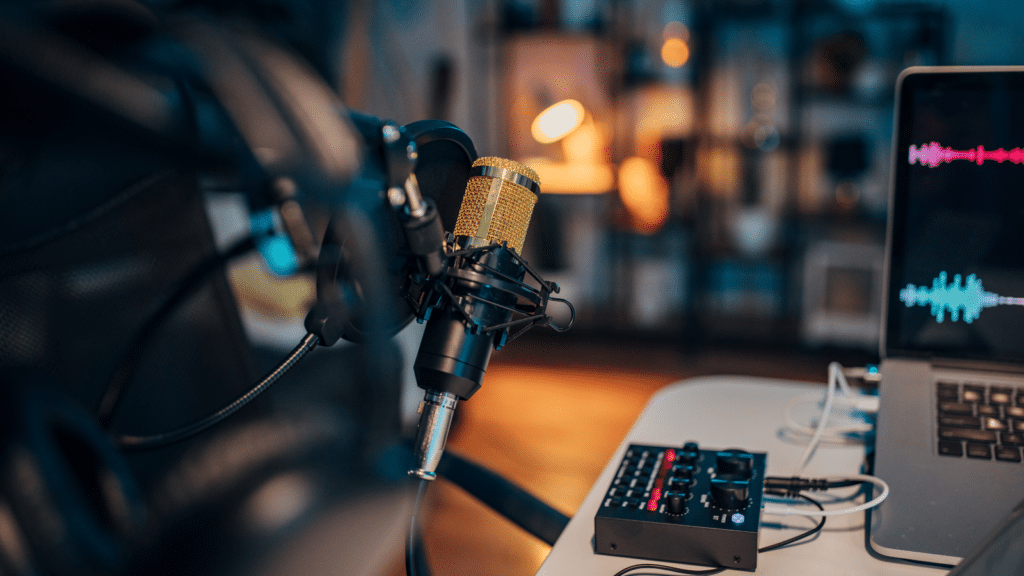 Podcasting microphone and audio mixer setup in a professional recording studio, representing the growth of sports podcasts.